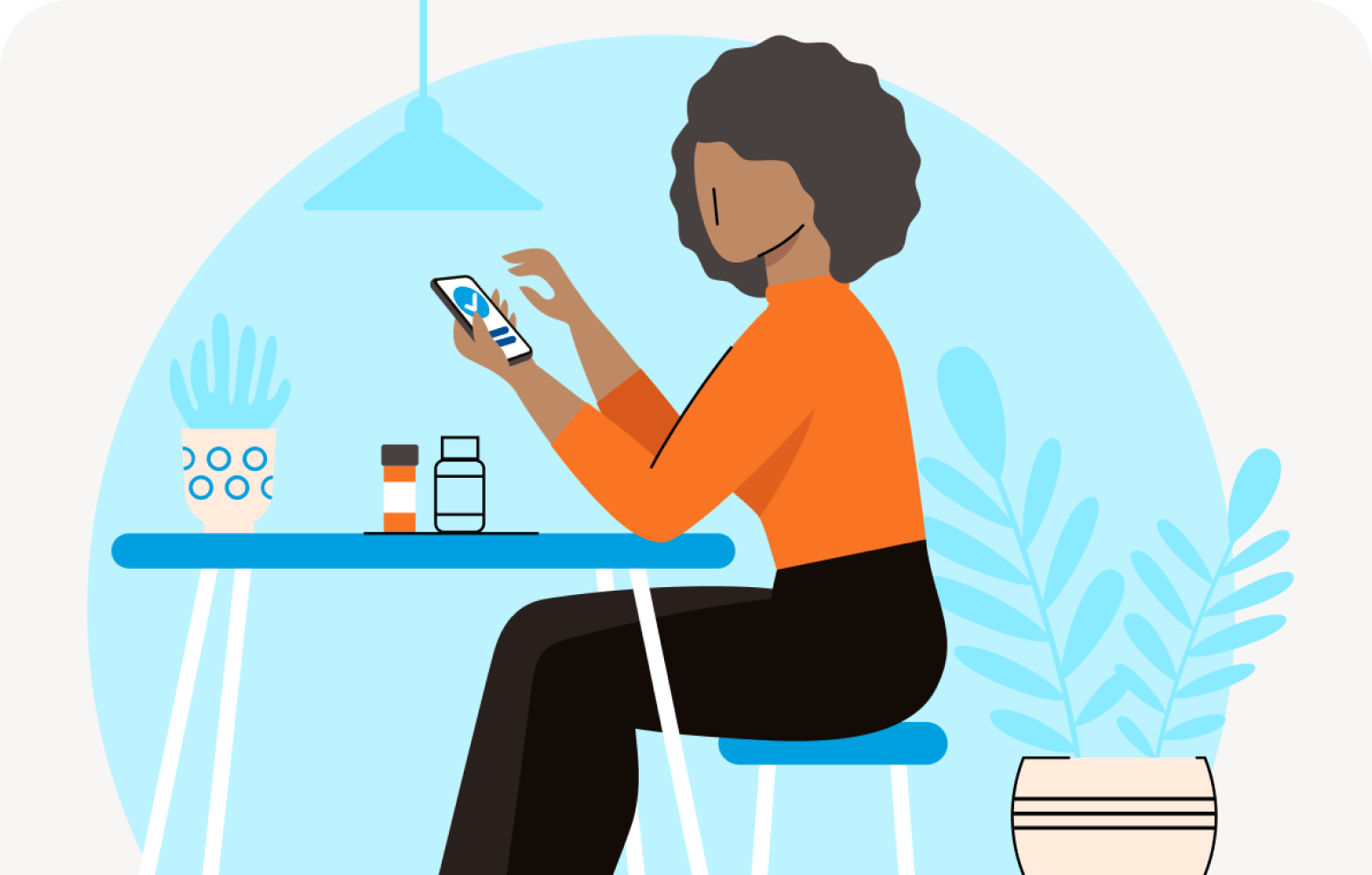 Woman looking at mobile while sitting at a dining area
